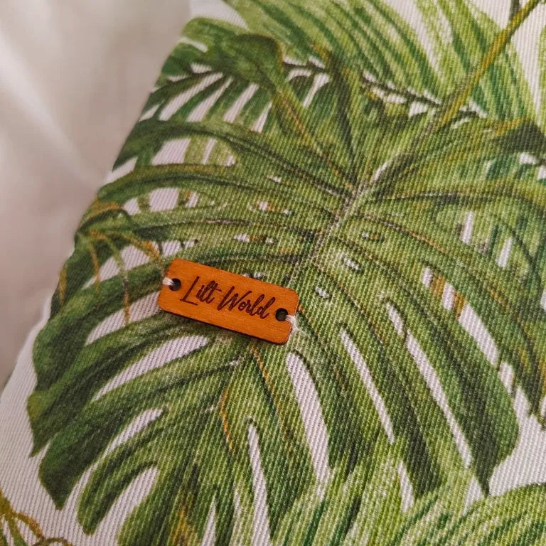 Detalle de la chapa de madera de Lilt World cosida sobre el estampado botánico.